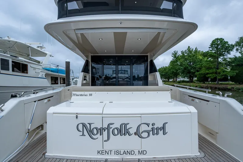 Norfolk Girl Yacht Photos Pics 2023 Maritimo M55 yacht docked, rear view with "Norfolk Girl" name, Kent Island, MD.