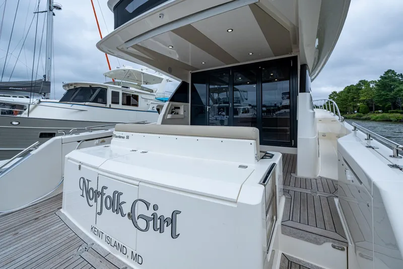 Norfolk Girl Yacht Photos Pics 2023 Maritimo M55 yacht docked, featuring sleek design and spacious deck area.