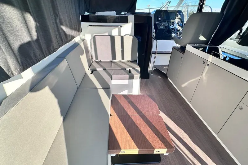  Yacht Photos Pics Interior of 2024 Beneteau Antares 11 OB, featuring modern seating and sleek design.