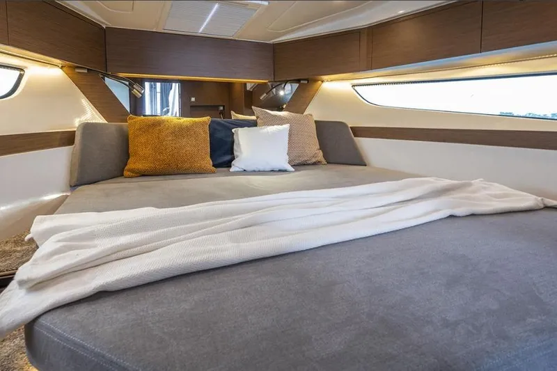  Yacht Photos Pics Luxurious cabin interior of 2024 Beneteau Antares 11 OB with cozy bedding.