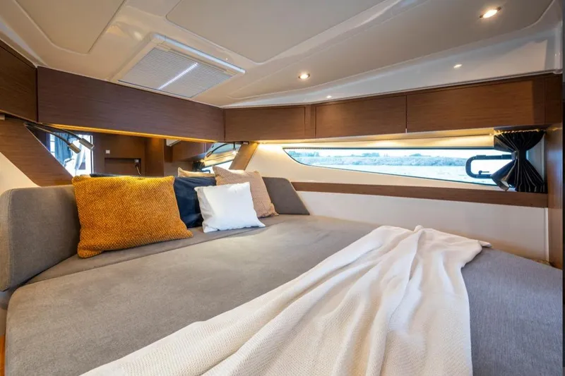  Yacht Photos Pics Luxurious cabin interior of 2024 Beneteau Antares 11 OB with cozy bedding and modern design.