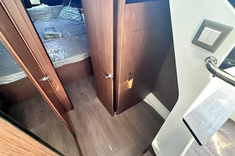  Yacht Photos Pics 2024 Beneteau Antares 11 OB interior with wood finish and modern design elements.