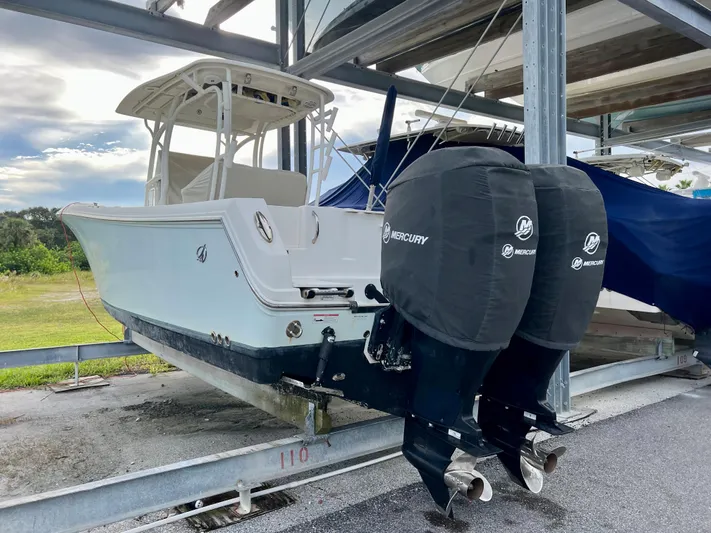 Mystic Wench Yacht Photos Pics 2014 Sailfish 290 CC boat with twin Mercury engines on a dry dock.