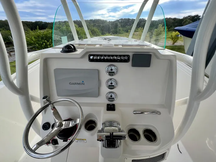 Mystic Wench Yacht Photos Pics 2014 Sailfish 290 CC boat dashboard with Garmin navigation system and steering wheel.
