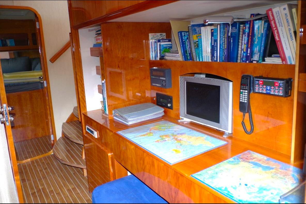 Luxurious Privilege 49 yacht interior with navigation desk, maps, and books, 2004 model.