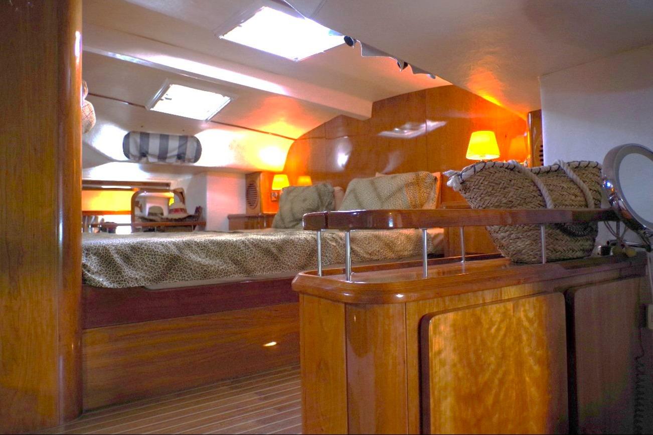 Luxurious interior of 2004 Privilege 49 yacht with cozy lighting and elegant wood finishes.