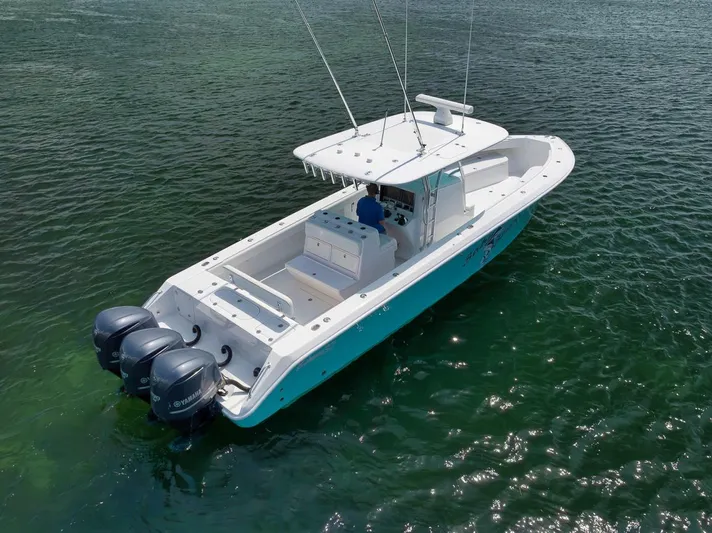 Baby Blues Yacht Photos Pics 2013 Bahama 37 boat with triple outboard engines on calm water.