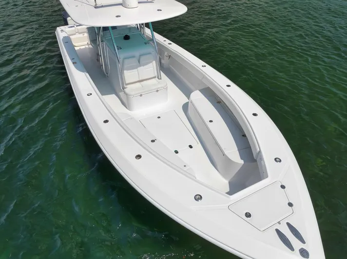 Baby Blues Yacht Photos Pics 2013 Bahama 37 boat on clear water, showcasing sleek design and spacious deck.