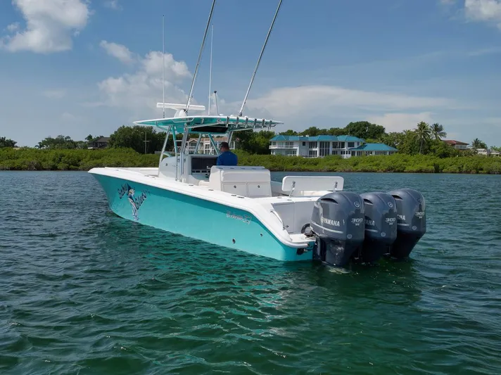 Baby Blues Yacht Photos Pics 2013 Bahama 37 boat with triple Yamaha engines on calm water.