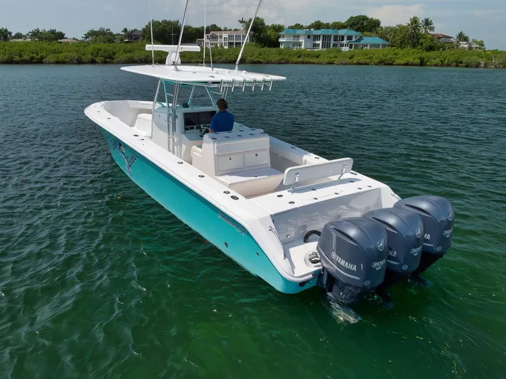 Baby Blues Yacht Photos Pics 2013 Bahama 37 boat with triple Yamaha engines on calm water.