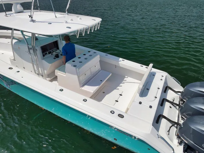 Baby Blues Yacht Photos Pics Bahama 37 boat, 2013 model, with triple engines, cruising on calm water.