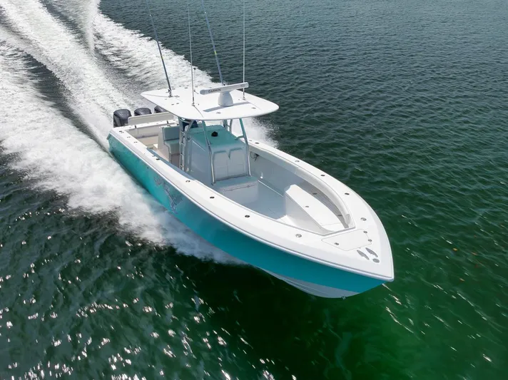 Baby Blues Yacht Photos Pics 2013 Bahama 37 boat cruising on open water, showcasing sleek design and powerful performance.