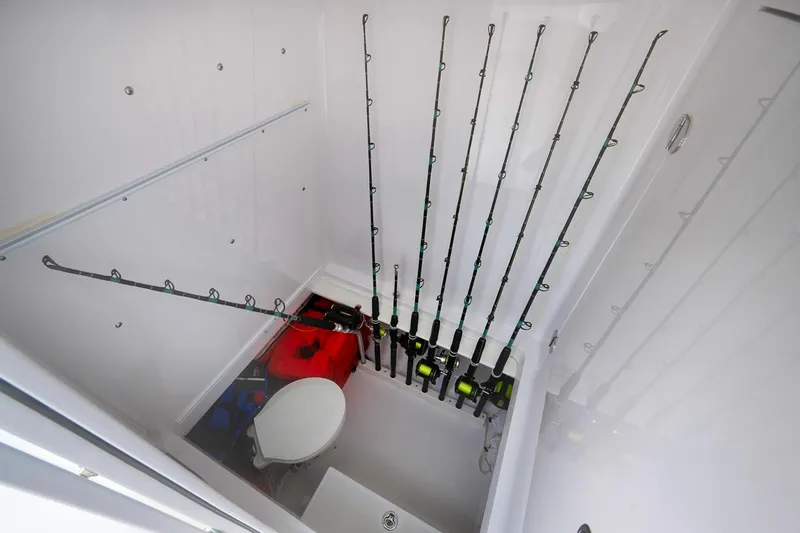 Baby Blues Yacht Photos Pics 2013 Bahama 37 boat interior with fishing rods and storage area.