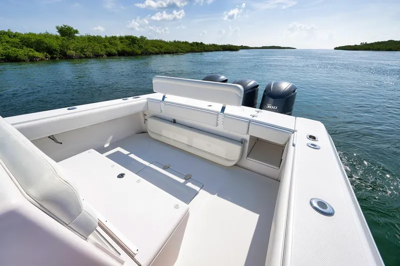 Baby Blues Yacht Photos Pics 2013 Bahama 37 boat on serene water, featuring spacious deck and dual engines.