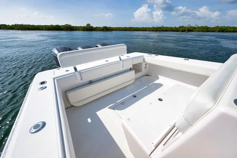 Baby Blues Yacht Photos Pics 2013 Bahama 37 boat interior with seating, on calm water.