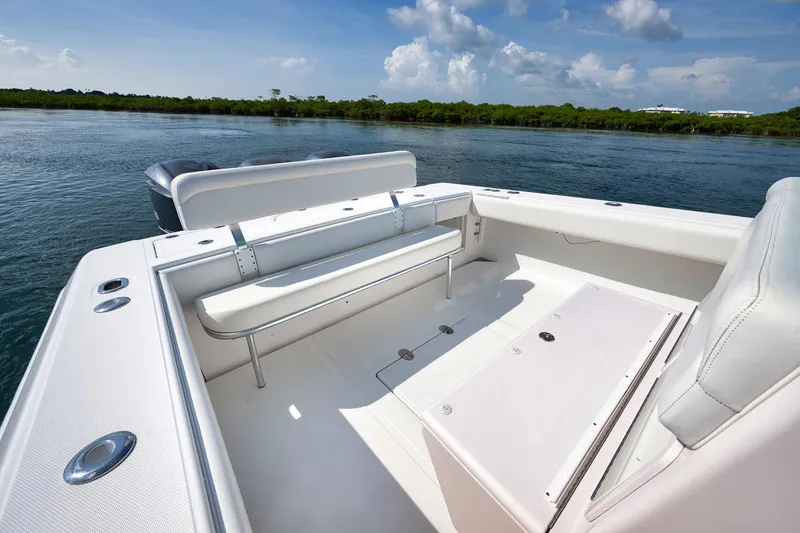 Baby Blues Yacht Photos Pics 2013 Bahama 37 boat interior with seating, on calm water under a blue sky.