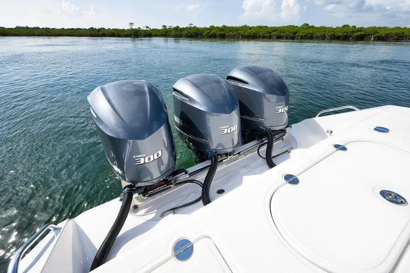 Baby Blues Yacht Photos Pics 2013 Bahama 37 boat with triple 300 horsepower outboard engines on a calm waterway.