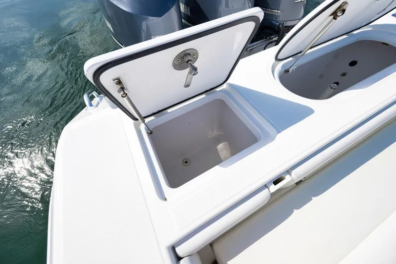 Baby Blues Yacht Photos Pics Open storage compartments on a 2013 Bahama 37 boat, with water in the background.