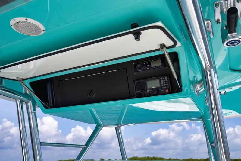 Baby Blues Yacht Photos Pics 2013 Bahama 37 boat electronics compartment with radio and navigation equipment under turquoise canopy.