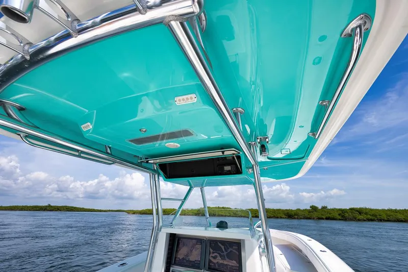 Baby Blues Yacht Photos Pics Bahama 37 boat, 2013 model, turquoise canopy, open water, clear sky.