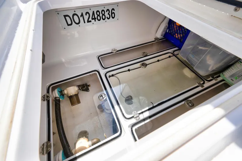 Baby Blues Yacht Photos Pics Storage compartment of 2013 Bahama 37 boat with visible equipment and serial number.