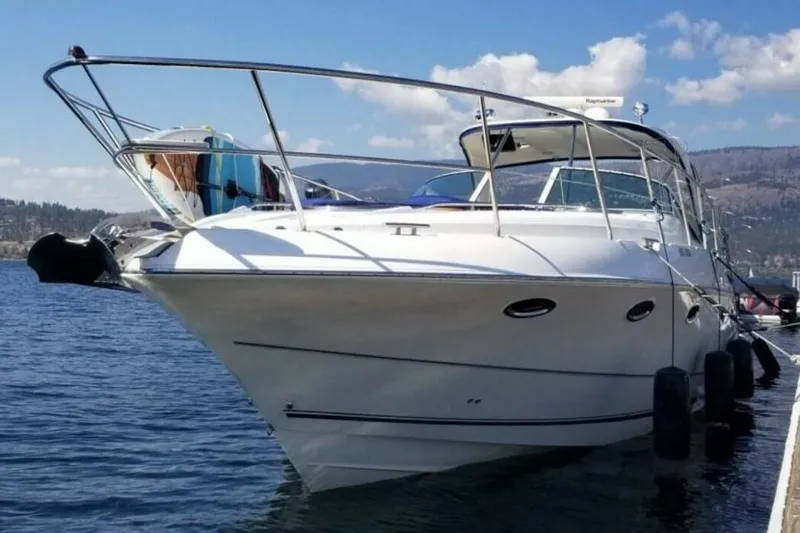  Yacht Photos Pics 2005 Doral Alegria boat docked on a sunny day with scenic mountain backdrop.