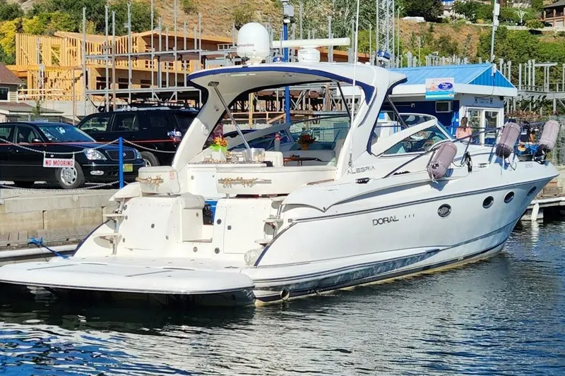  Yacht Photos Pics Luxury 2005 Doral Alegria yacht docked at marina with scenic background.