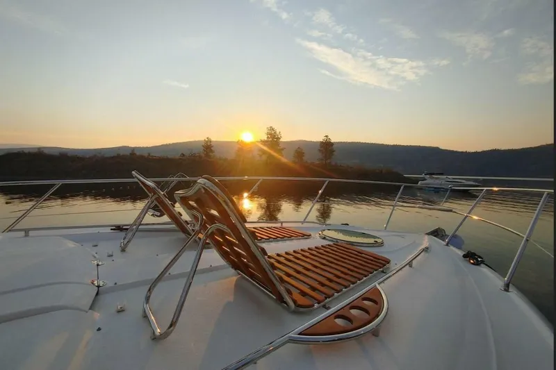 Yacht Photos Pics 2005 Doral Alegria yacht deck at sunset on tranquil water.