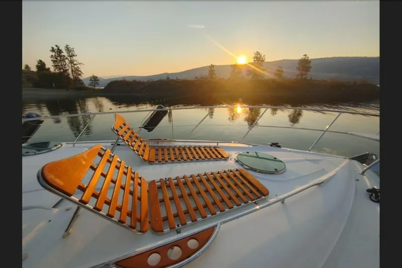  Yacht Photos Pics 2005 Doral Alegria boat deck with sunset view over calm water.