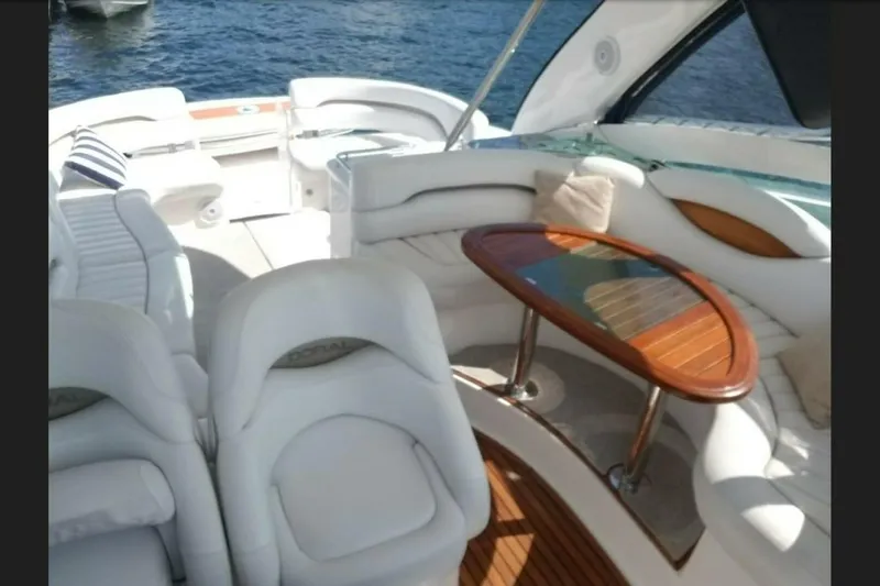  Yacht Photos Pics Luxurious 2005 Doral Alegria yacht interior with elegant seating and wooden table.
