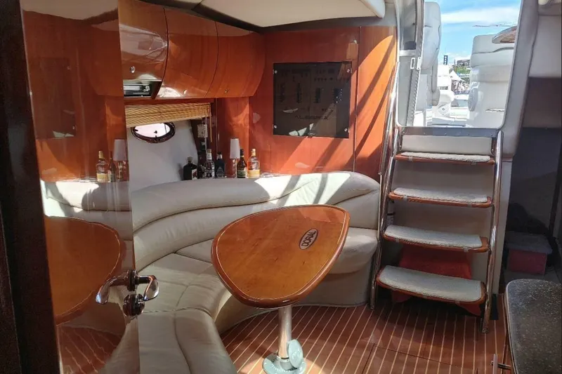  Yacht Photos Pics Luxurious 2005 Doral Alegria yacht interior with elegant wood finishes and cozy seating area.