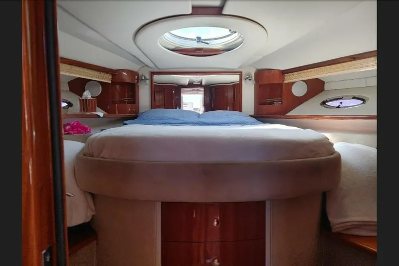  Yacht Photos Pics Luxurious interior of 2005 Doral Alegria yacht with cozy bed and elegant wood finish.