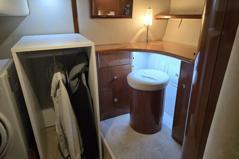  Yacht Photos Pics 2005 Doral Alegria yacht interior with wooden cabinetry, closet, and seating area.