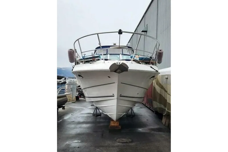  Yacht Photos Pics 2005 Doral Alegria boat on dry dock, front view, near industrial building.