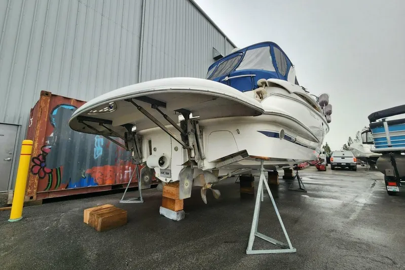  Yacht Photos Pics 2005 Doral Alegria boat on stands in a storage yard, with a blue canopy.