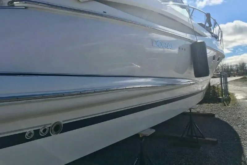  Yacht Photos Pics 2005 Doral Alegria boat on stands, side view under clear sky.