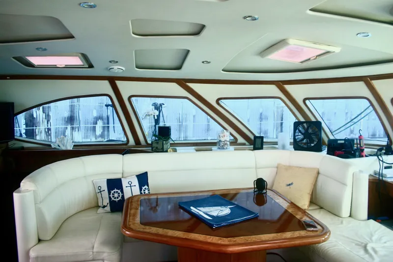 Que Sera Yacht Photos Pics Luxurious interior of 2009 Prout 45S yacht with elegant seating and panoramic windows.