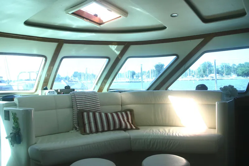Que Sera Yacht Photos Pics Luxurious interior of 2009 Prout 45S yacht with panoramic windows and plush seating.