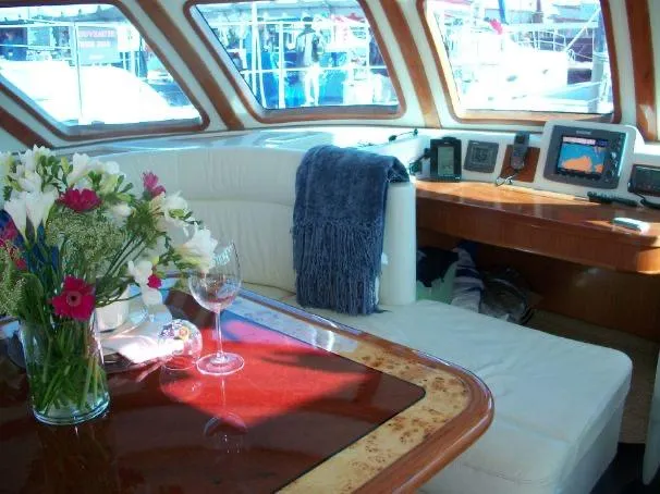 Que Sera Yacht Photos Pics Luxurious interior of 2009 Prout 45S yacht with elegant seating and floral arrangement.