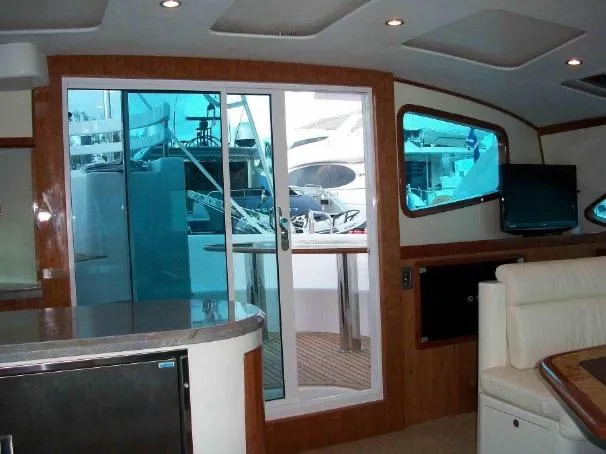 Que Sera Yacht Photos Pics Interior of 2009 Prout 45S yacht with modern furnishings and sliding glass door.
