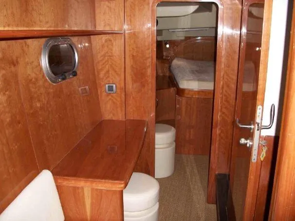 Que Sera Yacht Photos Pics Luxurious wooden interior of 2009 Prout 45S yacht cabin with desk and bed.