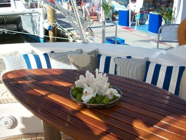 Que Sera Yacht Photos Pics Luxurious Prout 45S yacht deck with striped cushions and elegant floral centerpiece, 2009 model.