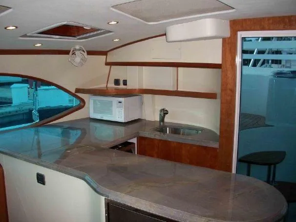 Que Sera Yacht Photos Pics Interior of 2009 Prout 45S yacht with modern kitchen and sleek countertops.