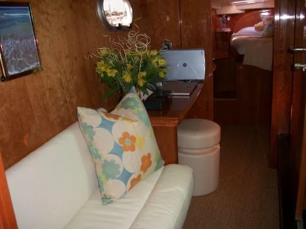 Que Sera Yacht Photos Pics Luxurious interior of 2009 Prout 45S yacht with cozy seating and floral decor.