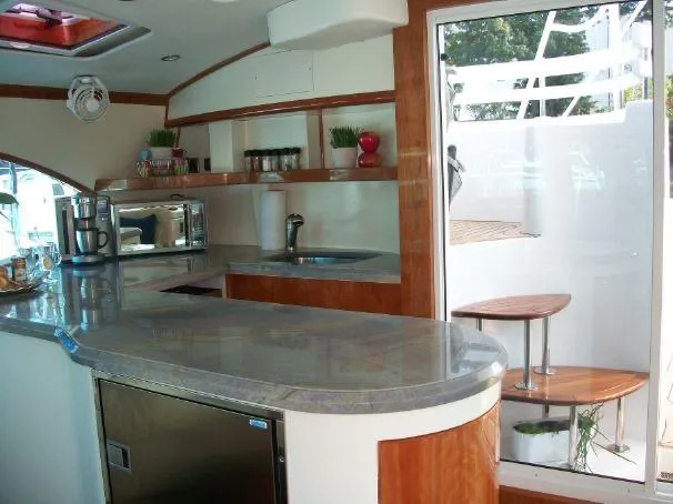 Que Sera Yacht Photos Pics Luxurious 2009 Prout 45S yacht interior with modern kitchen and sleek design.