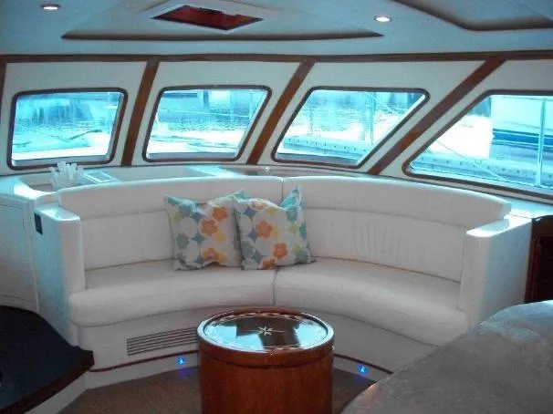 Que Sera Yacht Photos Pics Luxurious interior of 2009 Prout 45S yacht with white seating and decorative pillows.