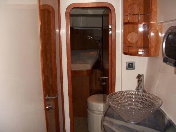 Que Sera Yacht Photos Pics Interior of 2009 Prout 45S yacht featuring wooden cabinetry and modern glass sink.