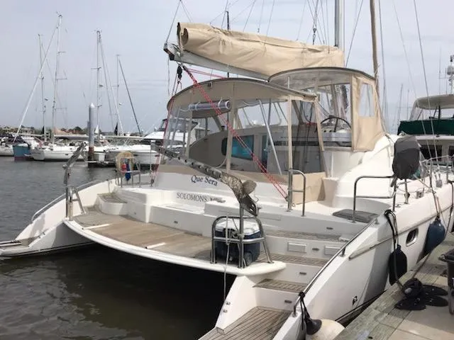 Que Sera Yacht Photos Pics 2009 Prout 45S catamaran docked at marina, featuring spacious deck and beige canopy.