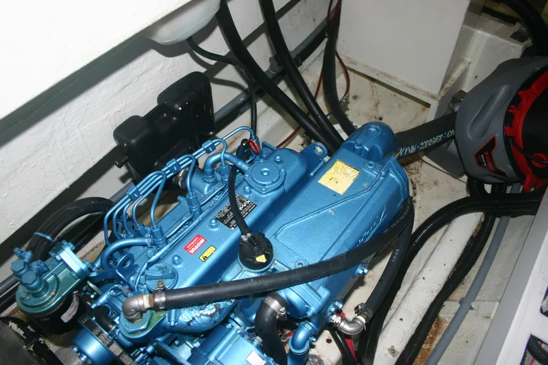Que Sera Yacht Photos Pics Engine compartment of a 2009 Prout 45S, featuring a blue marine engine with visible wiring.