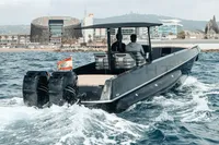 A 2008 FB Design Fabio Buzzi FB 38/19 S boat cruising near a city shoreline.